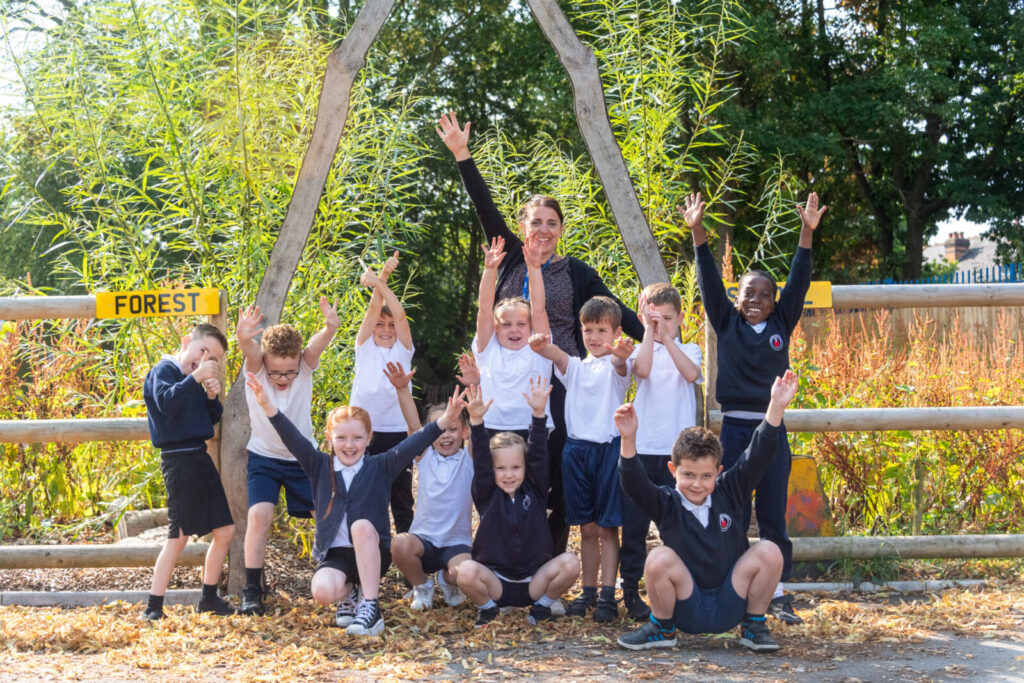 a picture of students and a teacher outside the forest