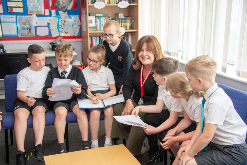 a picture of a teacher talking to the class