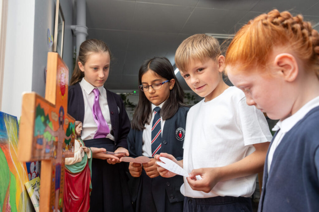 a picture of students around a cross