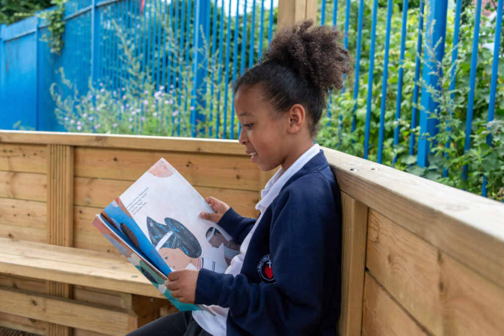 a picture of a student reading a book in the shack